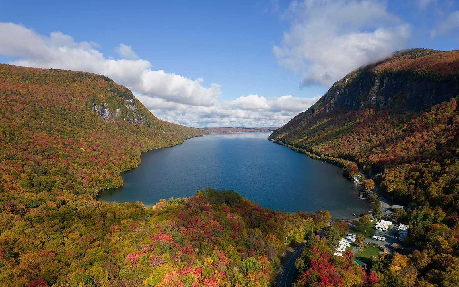Aerial view of Lake Willoughby in Westmore, Vermont, with Mount Hor on the left and Mount Pisgah on the right in peak fall foliage